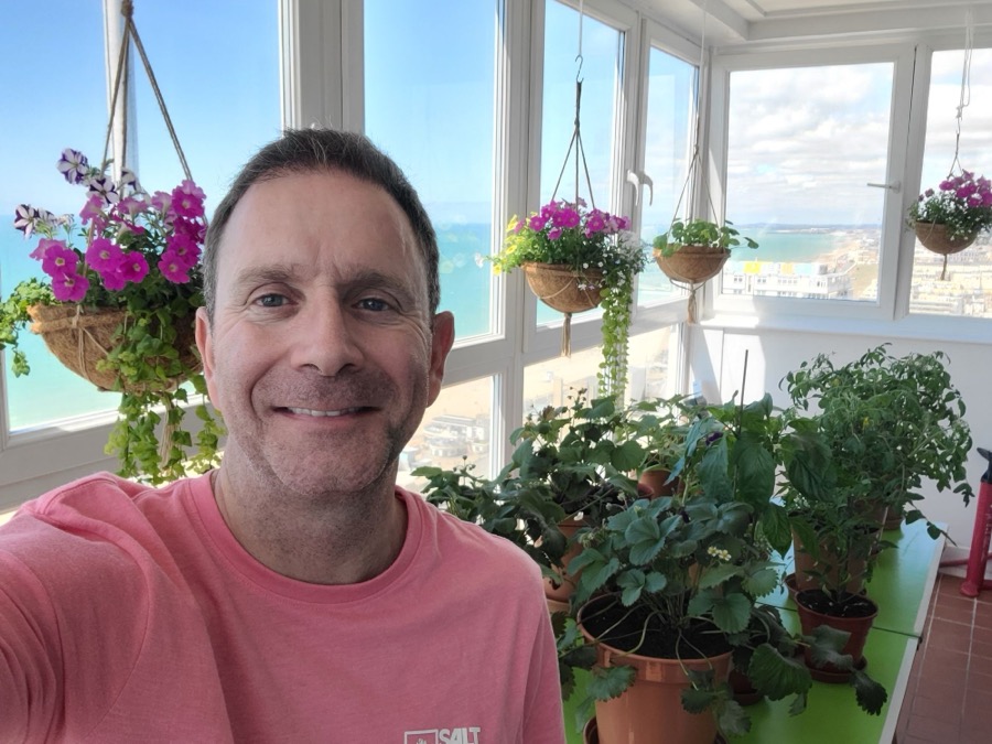 Alan Hudson on his balcony garden overlooking the sea in Brighton